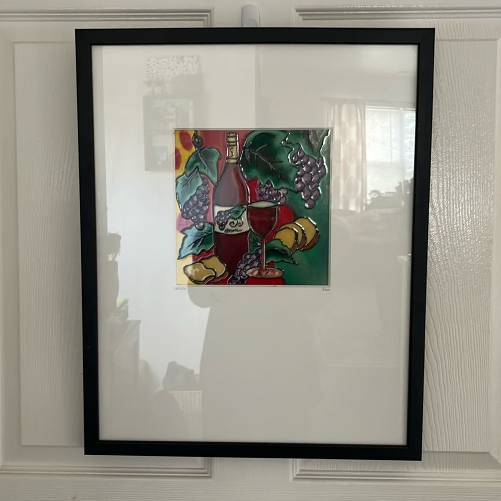 Stained glass picture of wine, cheese and grapes.